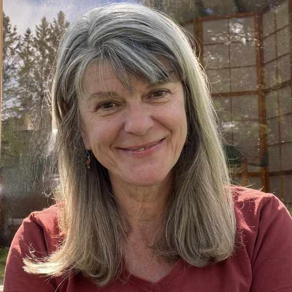 Smiling woman with long, ash blonde hair.